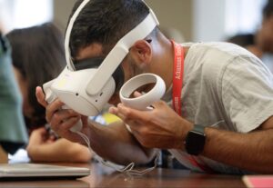 Student looking down while wearing a Meta Occulus headset.